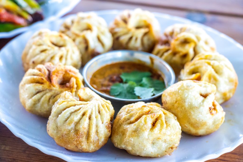 Momos served with the red chutney they are usually eaten with
